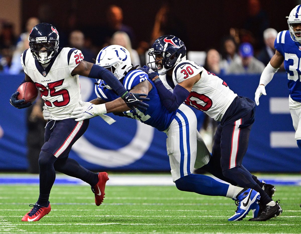 Jan 6, 2024; Indianapolis, Indiana, USA; Houston Texans cornerback Desmond King II (25) is tackled by Indianapolis Colts running back Zack Moss (21) during the second quarter at Lucas Oil Stadium. Mandatory Credit: Marc Lebryk-USA TODAY Sports
