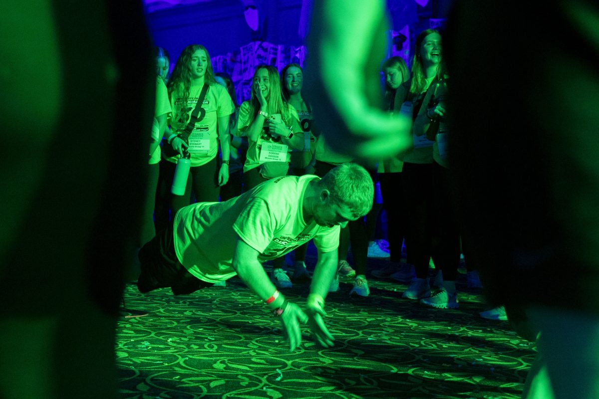 An attendee does clapping pushups in a dance circle during the University of Iowa’s 30th Dance Marathon at the Iowa Memorial Union in Iowa City on Saturday, Feb. 3, 2024. 