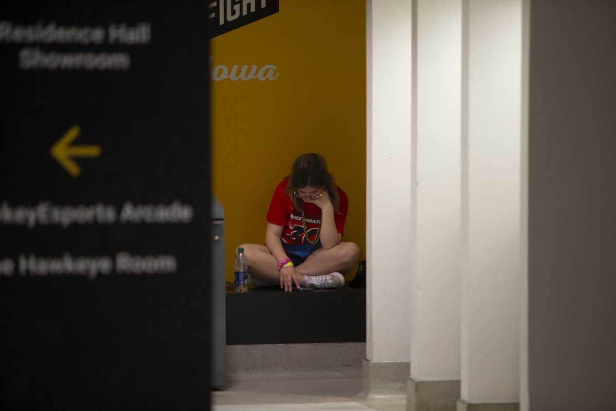 A dance marathon participant sits down during the University of Iowa’s 30th Dance Marathon at the Iowa Memorial Union in Iowa City on Friday, Feb. 3, 2024.