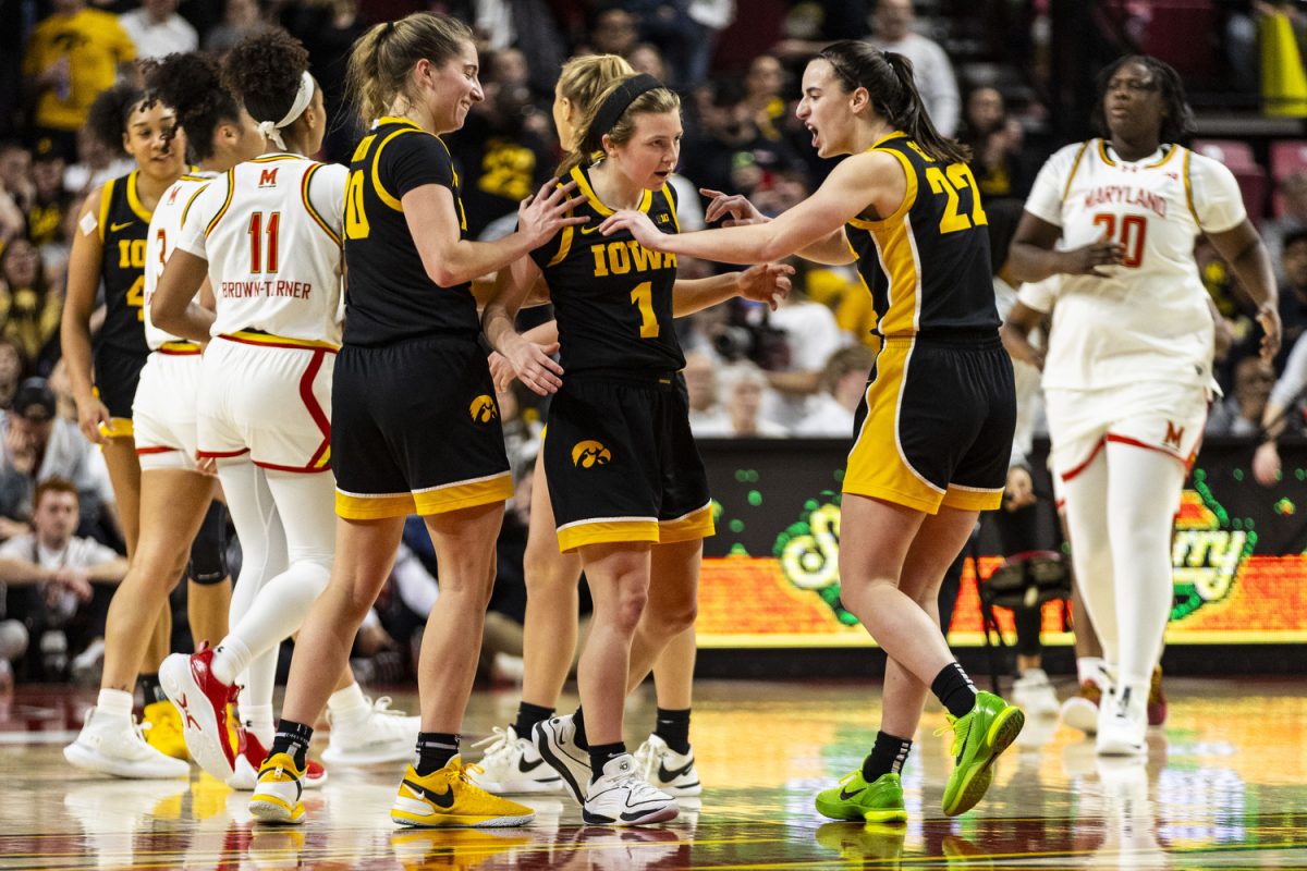 Iowa guard Caitlin Clark and Iowa guard Kate Martin celebrate a play by Iowa guard Molly Davis during a women’s basketball game between No. 3 Iowa and Maryland at a sold-out Xfinity Center in College Park, Md., on Saturday, Feb. 3, 2024. The Hawkeyes defeated the Terrapins, 93-85.