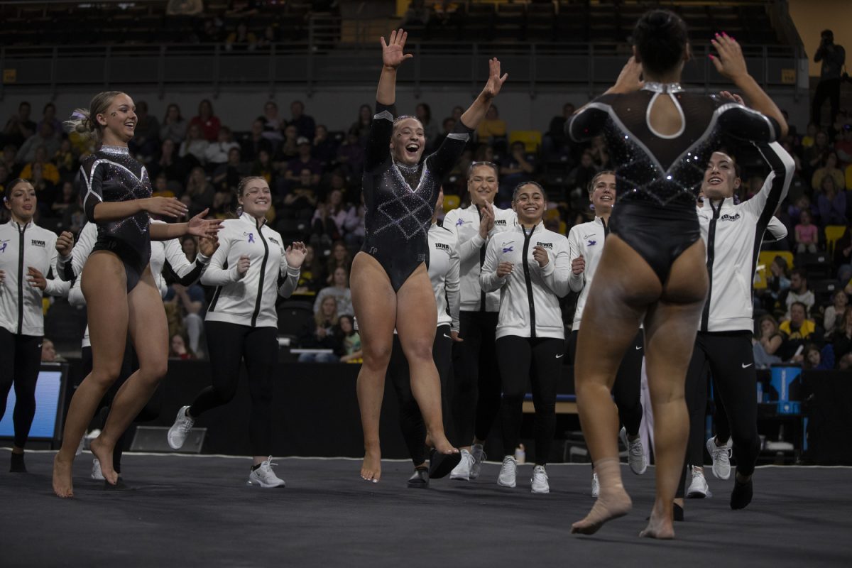 Iowa gymnasts celebrate after Hannah Castillo finishes a floor routine during a gymnastics meet between No. 27. University of Iowa and No. 26 University of Nebraska at Xtream Arena on Sunday, Feb. 4, 2024. The Cornhuskers defeated the Hawkeyes, 196.5- 195.725. 