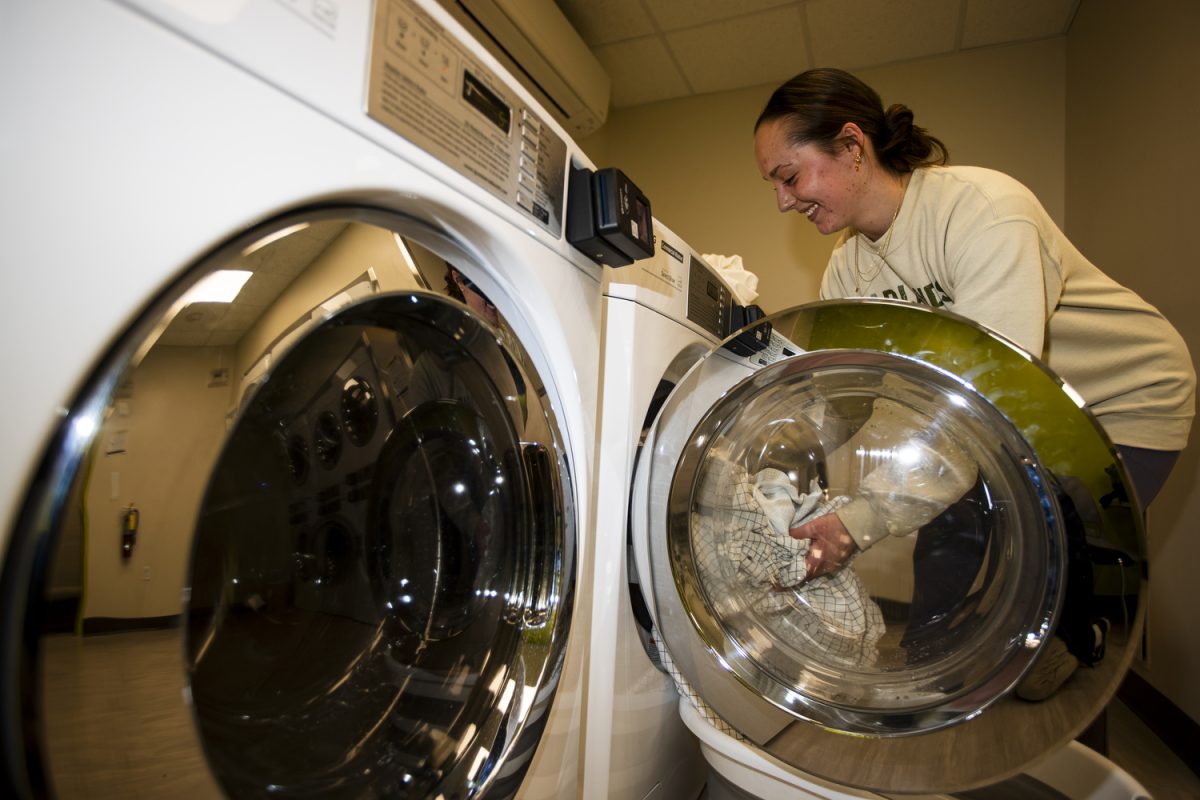 University of Iowa student Ava Goldsmith does laundry at Hillcrest residence hall in Iowa City on Sunday, Feb. 4, 2024. 