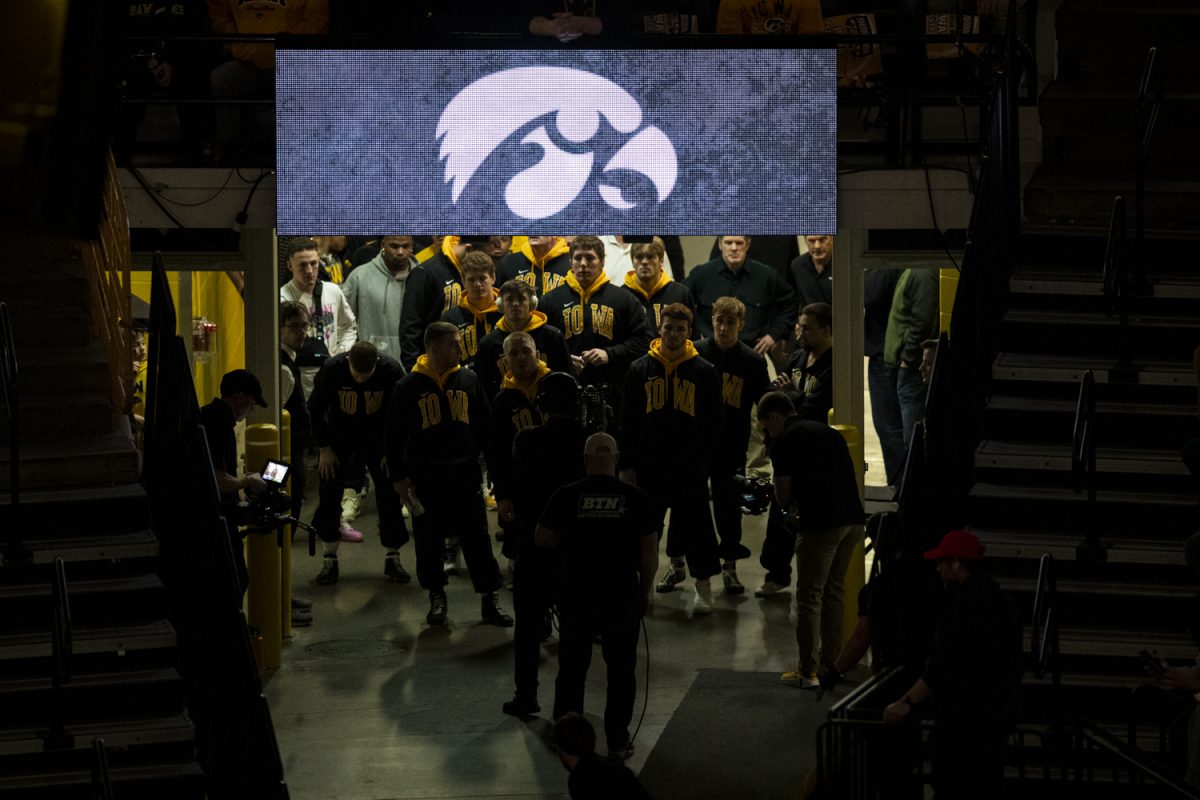 The Iowa wrestling team walks down the tunnel before a wrestling dual between No. 3 Iowa and No. 1 Penn State at Carver-Hawkeye Arena on Friday, Feb. 9, 2024. The Nittany Lions defeated the Hawkeyes, 29-6. Before the dual, Iowa’s record sat at 10-1. (Ayrton Breckenridge/The Daily Iowan)