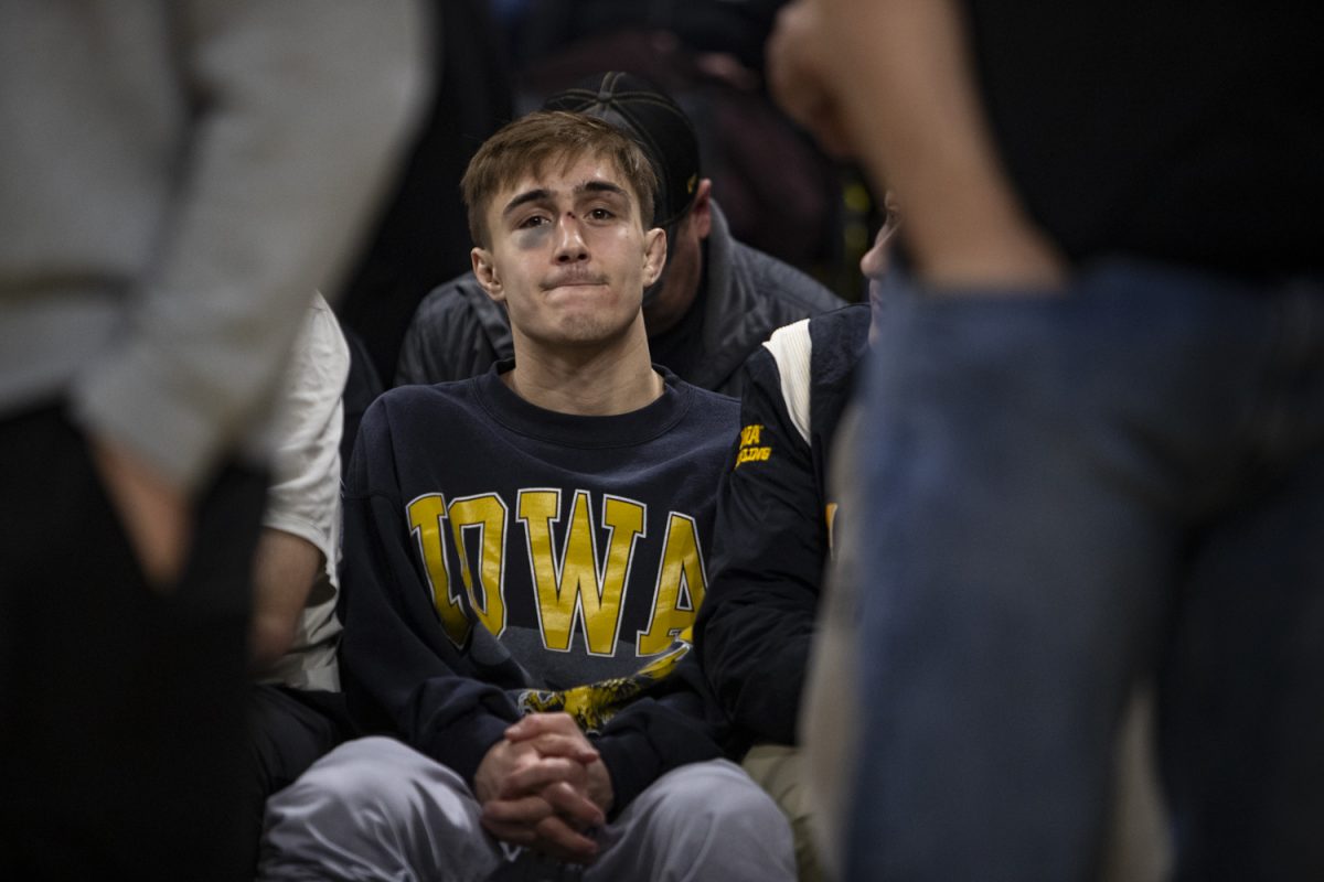 Iowa’s No. 7 125-pound Drake Ayala sits on the bench during a wrestling dual between No. 3 Iowa and No. 1 Penn State at Carver-Hawkeye Arena on Friday, Feb. 9, 2024. The Nittany Lions defeated the Hawkeyes, 29-6. (Ayrton Breckenridge/The Daily Iowan)
