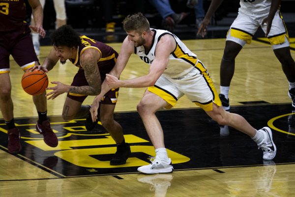 Minnesota guard Braden Carrington steals the ball from Iowa forward Ben Krikke during a men’s basketball game between Minnesota and Iowa at Carver-Hawkeye Arena on Sunday, Feb. 11, 2024. The Hawkeyes defeated the Gophers 90-85. Carrington had 18 points throughout the game. 

