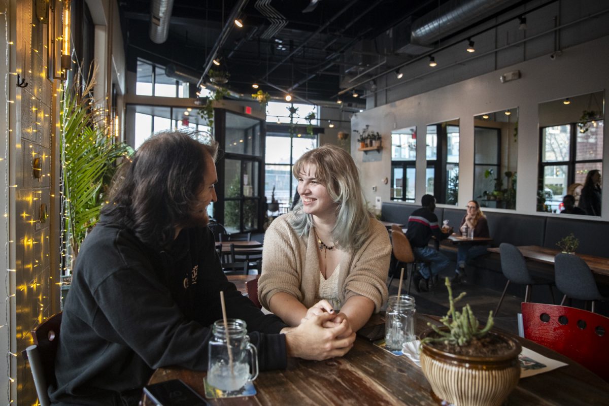 Magnus Wilson and Amanda Armstrong spend time together at The Green House in Iowa City on Monday, Feb. 12, 2024. Wilson and Amanda met on Tinder in 2021 and plan to get married this summer. 