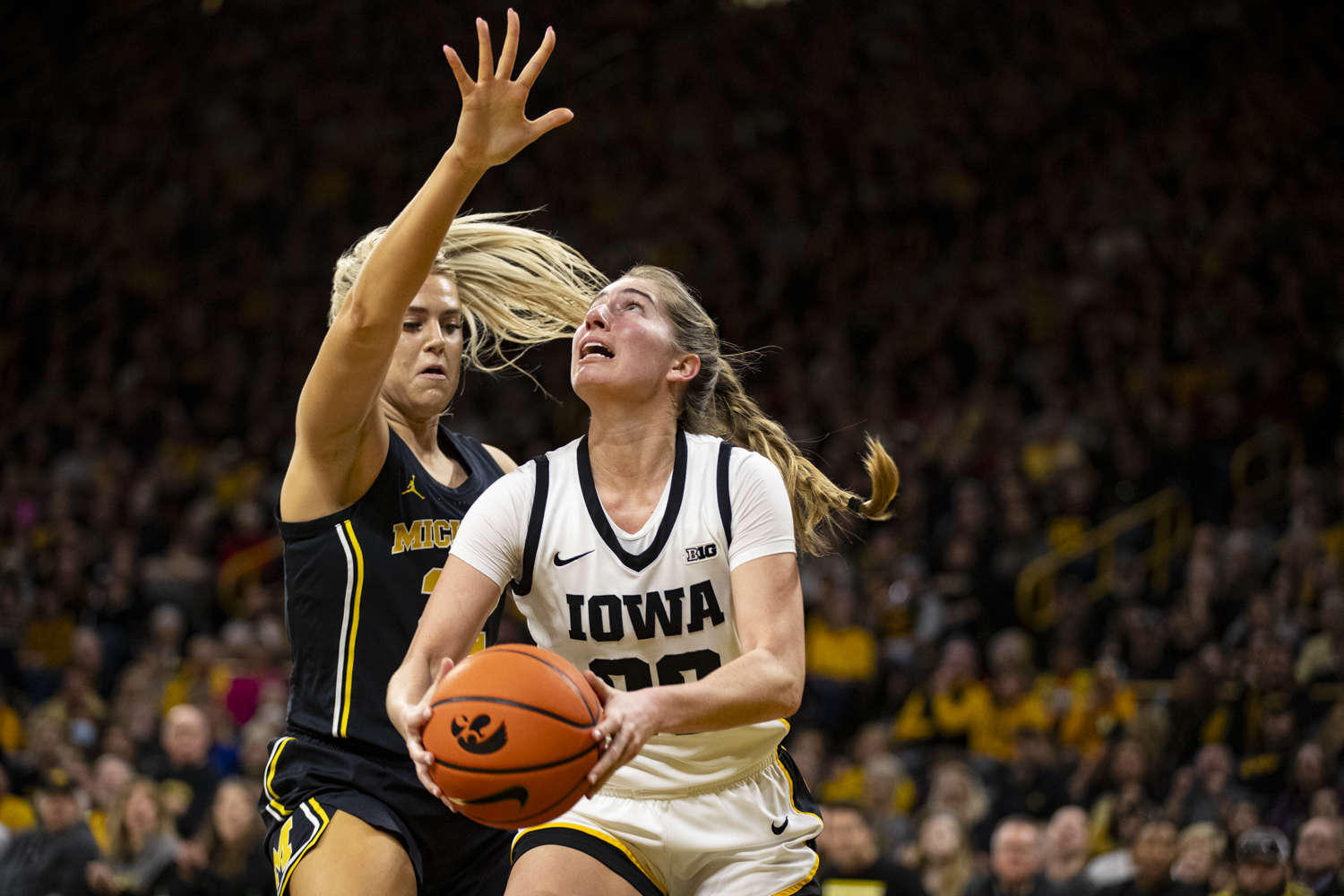 Iowa guard Kate Martin prepares to shoot the ball during a women’s basketball game between No. 4 Iowa and Michigan at Carver-Hawkeye Arena on Thursday, Feb. 15, 2024. The Hawkeyes defeated the Wolverines, 106-89. (Ayrton Breckenridge/The Daily Iowan)
