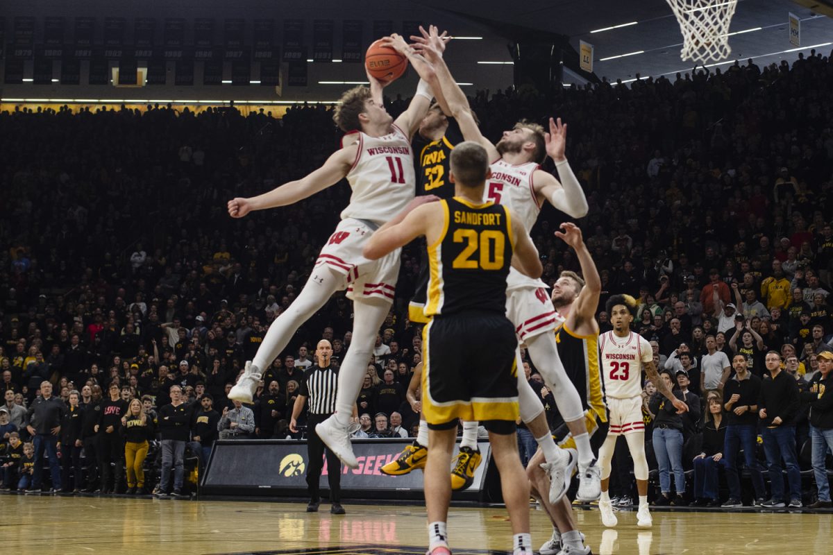 Wisconsin guard, Max Klesmit contests Iowa forward, Patrick McCaffery’s layup during a mens basketball game between Iowan and Wisconsin at Carver-Hawkeye Arena on Saturday, Feb. 17, 2024. The Hawkeyes defeated the Badgers in overtime, 88-86. 