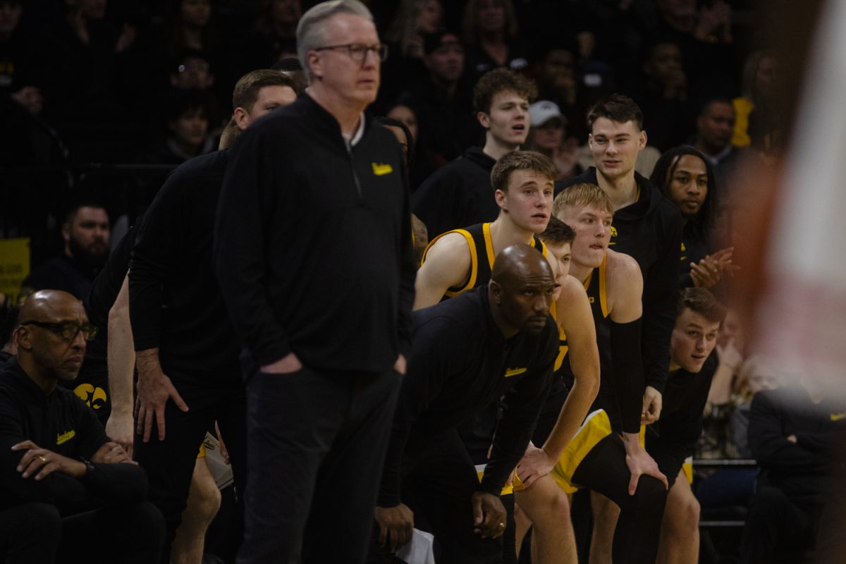 Members of the Iowa men’s basketball team react during a mens basketball game between Iowa and Wisconsin at Carver-Hawkeye Arena on Saturday, Feb. 17, 2024. The Hawkeyes defeated the Badgers in overtime, 88-86. 