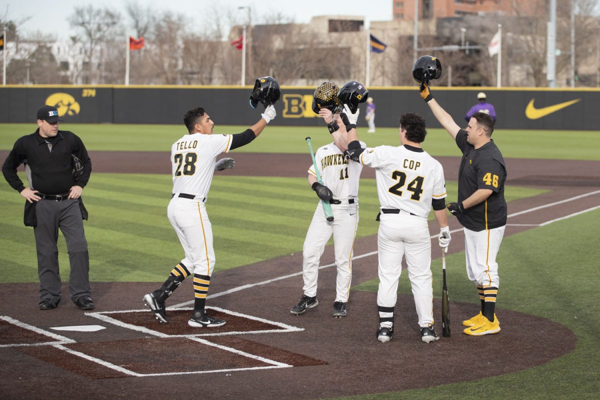 Iowa baseball players celebrate after Iowa third baseman Raider Tello scores a home run for Iowa during a baseball game between No. 18 Iowa and Loras College at Duane Banks Field on Tuesday, Feb. 20, 2024. The Hawkeyes defeated the Duhawks, 20-6.
