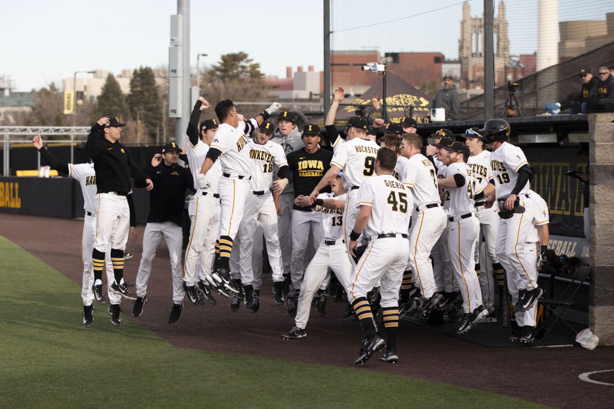 Iowa baseball players celebrate after Iowa third baseman Raider Tello scores a home run for Iowa during a baseball game between No. 18 Iowa and Loras College at Duane Banks Field on Tuesday, Feb. 20, 2024. The Hawkeyes defeated the Duhawks, 20-6.