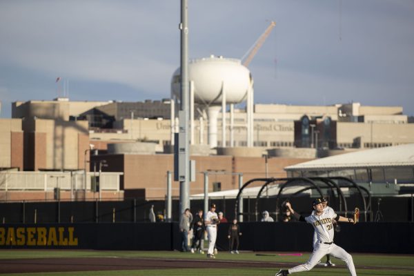 Iowa pitcher Chas Wheatley warms up before an inning during a baseball game between No. 18 Iowa and Loras College at Duane Banks Field on Tuesday, Feb. 20, 2024. The Hawkeyes defeated the Duhawks, 20-6.