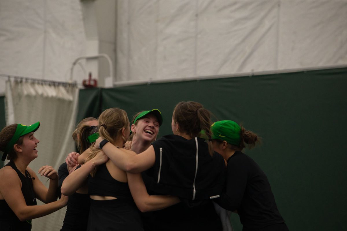Oregon’s Karin Young celebrates with teammates after clinching the win during a tennis meet between Iowa and Oregon at the Hawkeye Tennis and Recreation Complex in Iowa City on Friday, Feb. 23, 2024. The Ducks defeated the Hawkeyes, 4-3.