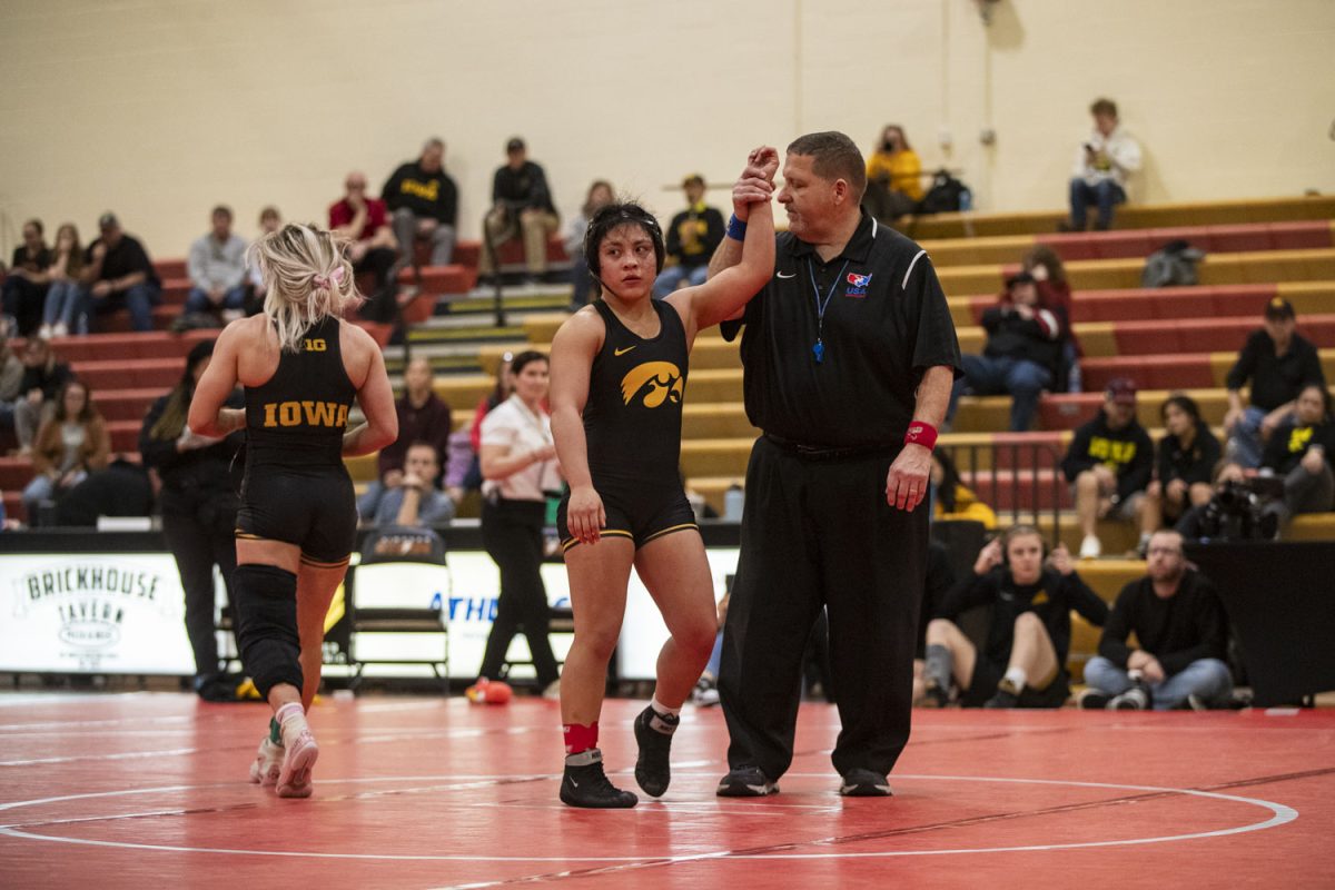 An official raises Iowa’s No. 3 116-pound Brianna Gonzalez’s hand during the NCWWC Regionals at Cowles Fieldhouse in Indianola, Iowa, on Friday, Feb. 23, 2024. The Hawkeyes advanced all 15 wrestlers to the national championships and led the team race with 222 points. Gonzalez defeated Taylor by decision, 9-3.