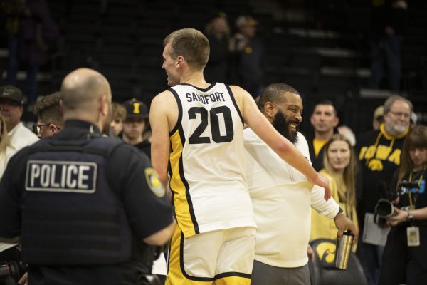 `Iowa Forward Payton Sandfort celebrates with Iowa teammates and staff after his historic performance during a men’s basketball game between Iowa and Penn State at Carver-Hawkeye Arena on Tuesday, Feb. 27, 2024. Sandfort recorded the first triple-double in program history. The Hawkeyes defeated the Nittany Lions, 90-81.