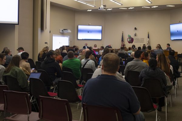 Spectators converse during an Iowa City Community School District school board meeting on Tuesday, Feb. 27, 2024.
