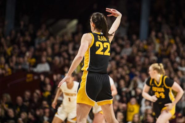 Iowa guard Caitlin Clark holds up a three after making a three pointer during a women’s basketball game between Iowa and Minnesota at Williams Arena in Minneapolis, MN, on Wednesday, Feb. 28, 2024. The Hawkeyes defeated the Gophers, 108-60. Clark completed 10 rebounds. 