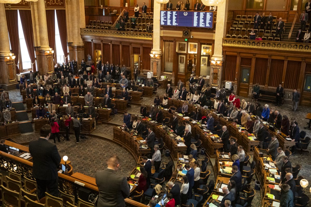 State representatives stand for a moment of silence for the school shooting that happened in Perry, Iowa, during the first day of the 2024 Iowa legislative session at the Iowa State Capitol in Des Moines on Monday, Jan. 8, 2024. The shooting took place on Jan. 4.