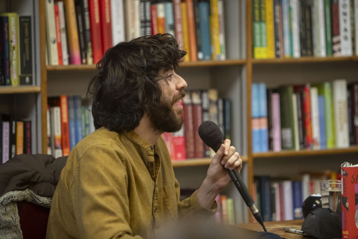 Kaveh Akbar speaks during a panel on Leslie Jamison’s newest novel, Splinters: Another Kind of Love Story, at Prairie Lights bookstore in Iowa City on Wednesday, Feb. 28, 2024.