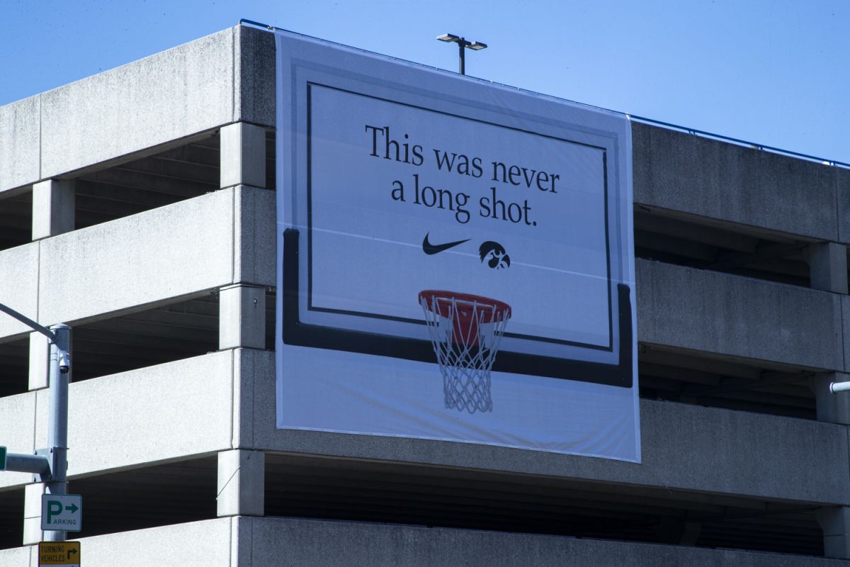 A Nike advertisement commemorates Iowa guard Caitlin Clark’s scoring record on the southeast corner of the Capitol Street Garage in Iowa City on Sunday, Mar. 3, 2024. The poster was hung after Clark sank a free throw just before half-time, passing Pistol Pete Maravich’s record for most points in NCAA collegiate basketball.