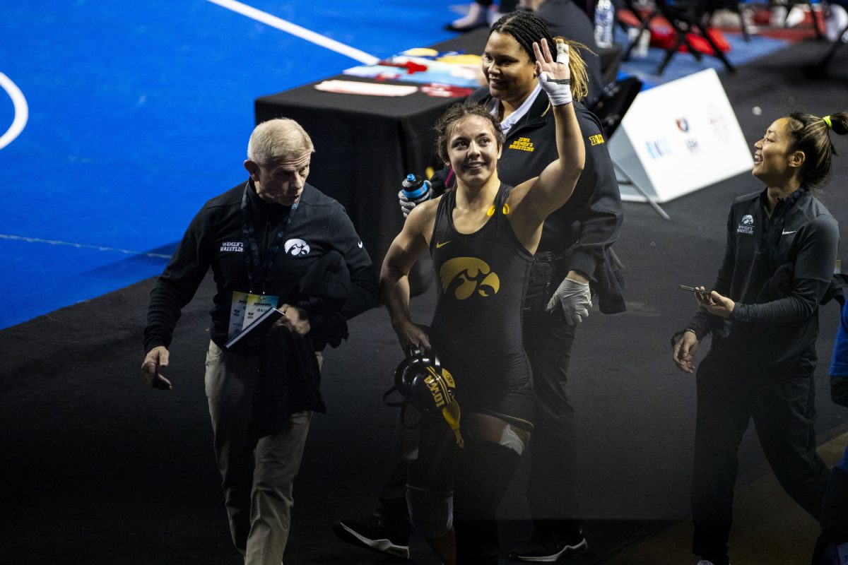 Iowa 138-pound Lilly Luft waves to fans after defeating Emmanuel College Gianna Anaya during the first day of the National Collegiate Women’s Wrestling Championships at Alliant Energy PowerHouse in Cedar Rapids, Iowa on Friday, March 8, 2024. Luft won by decision, 5-0.