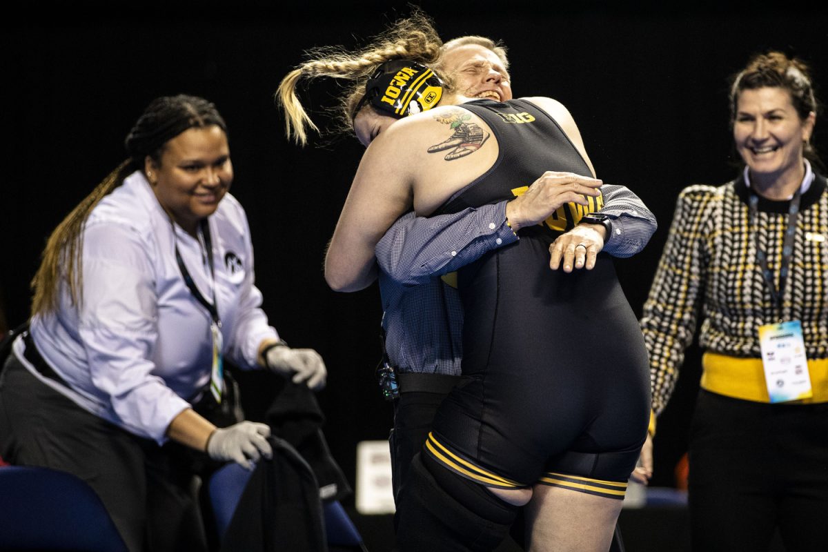Iowa+191-pound+Jaycee+Foeller+embraces+associate+head+coach+Gary+Mayabb+after+pinning+North+Central+College+Traeh+Haynes+during+the+second+day+of+the+National+Collegiate+Women%E2%80%99s+Wrestling+Championships+at+Alliant+Energy+PowerHouse+in+Cedar+Rapids%2C+Iowa+on+Saturday%2C+March+9%2C+2024.+%28Cody+Blissetti%2FThe+Daily+Iowan%29