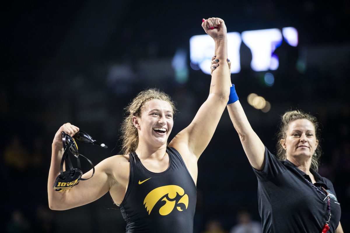 An official holds up Iowa 170-pound Kylie Welkers arm after she defeated North Central College Yelena Makoyed during the second day of the National Collegiate Women’s Wrestling Championships at Alliant Energy PowerHouse in Cedar Rapids, Iowa on Saturday, March 9, 2024. Welker defeated the three-time defending champion by technical fall, 11-0. 