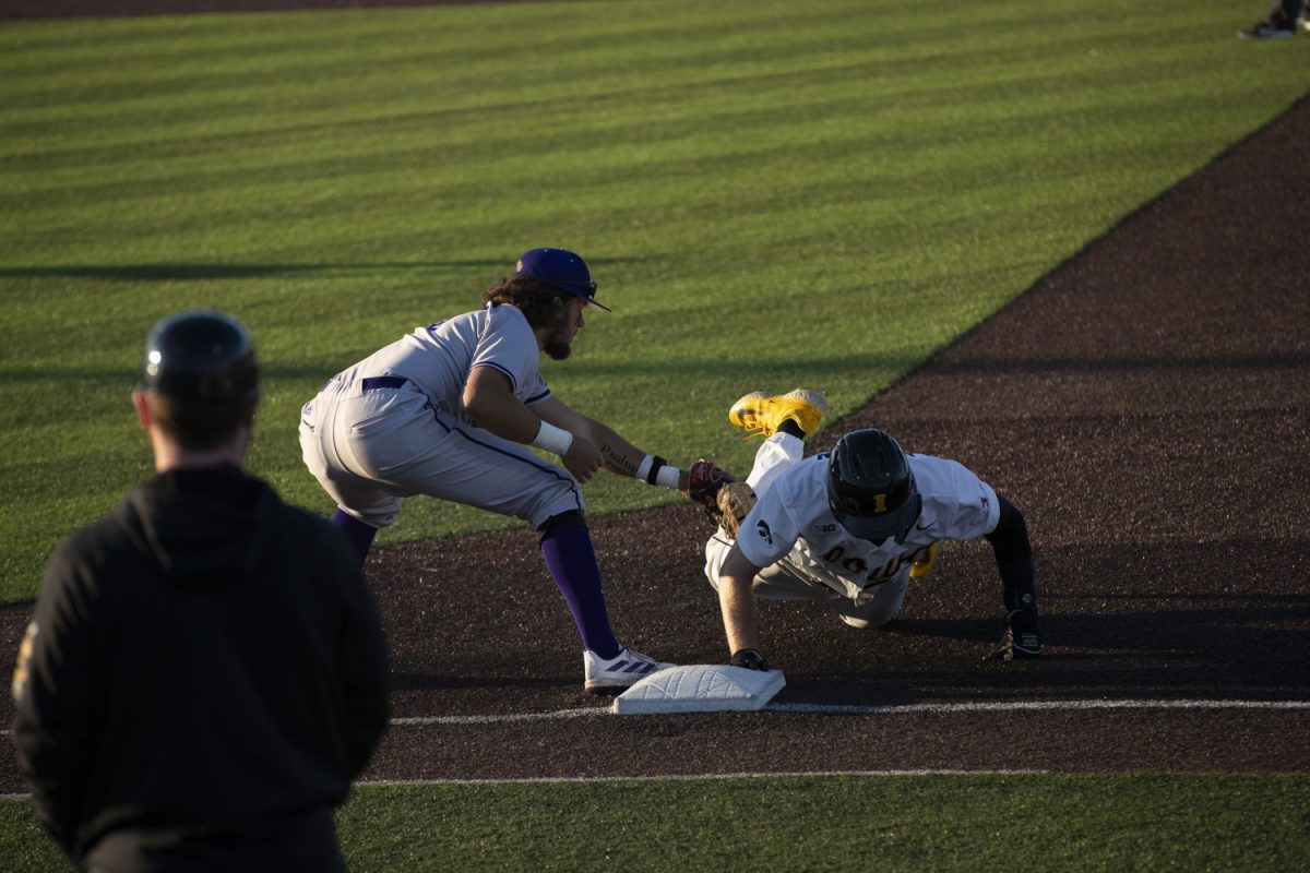 Western Illinois attempts to pick off an Iowa baserunner during a baseball game between Iowa and Western Illinois at Duane Banks Field on Friday, March 15, 2024. The Hawkeyes would win 11-1 in the eighth inning.