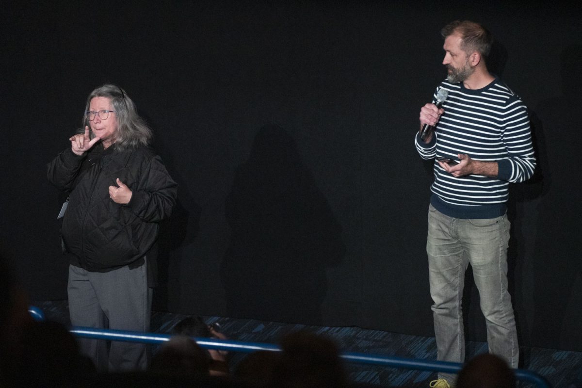 An ASL interpreter signs for the founder of FilmScene Andrew Sherburne during the Iowa Disability Film Festival: FULL CIRCLE at the Chauncey FilmScene on Wednesday, March 20, 2024.