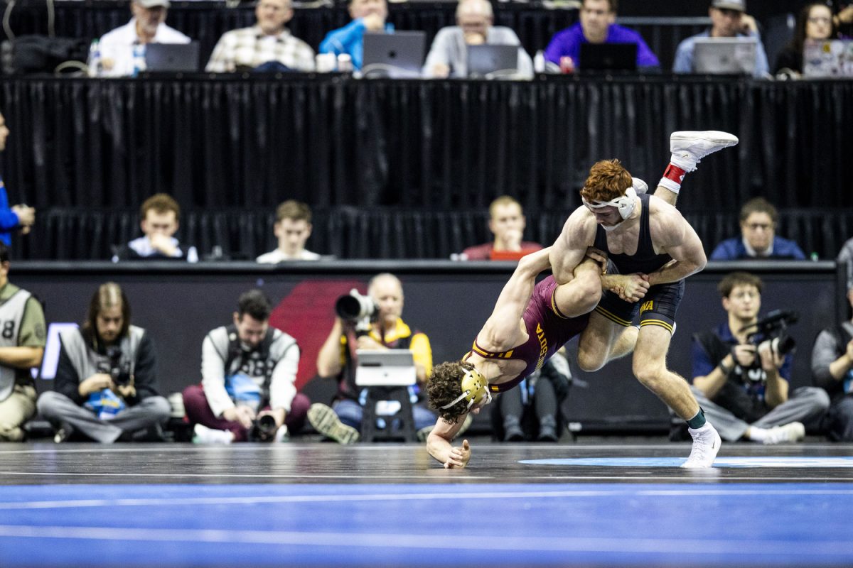 Iowa 165-pound Mike Caliendo wrestles Oklahoma State Izzak Olejnikduring the first session of the NCAA men’s wrestling championships at T-Mobile Center in Kansas City, Missouri on Thursday March 21, 2024