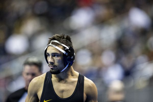 Iowa 141-pound Real Woods looks at his competition during the first session of the NCAA men’s wrestling championships at T-Mobile Center in Kansas City, Missouri on Thursday March 21, 2024
