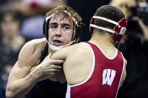 Iowa 125-pound Drake Ayala wrestles Wisconsin Eric Barnet during the fourth session of the NCAA men’s wrestling championships at T-Mobile Center in Kansas City, Missouri, on Friday, March 22, 2024. Ayala won by decision, 3-2.