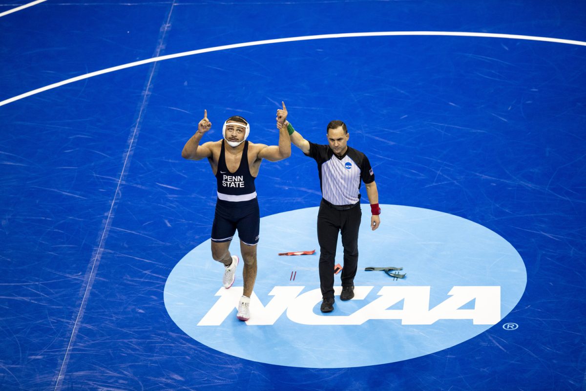 An official holds up Penn State 197-pound Aaron Brooks arm during the fourth session of the NCAA men’s wrestling championships at T-Mobile Center in Kansas City, Missouri, on Friday, March 22, 2024. Brooks defeated Missouri Rocky Elam by technical fall.