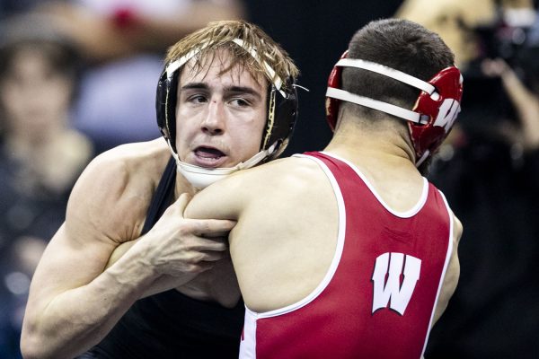 Iowa 125-pound Drake Ayala wrestles Wisconsin Eric Barnet during the fourth session of the NCAA men’s wrestling championships at T-Mobile Center in Kansas City, Missouri, on Friday, March 22, 2024. Ayala won by decision, 3-2. 