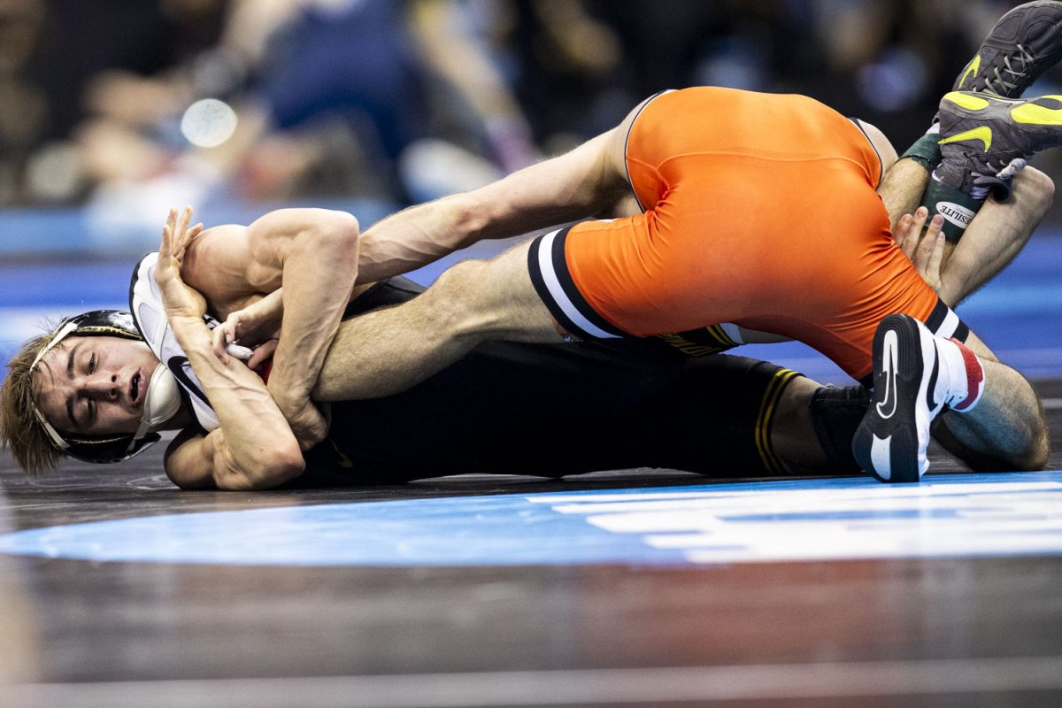 Iowa 125-pound Drake Ayala wrestles Oklahoma State Troy Spratley during the third session of the NCAA men’s wrestling championships at T-Mobile Center in Kansas City, Missouri, on Friday, March 22, 2024. 