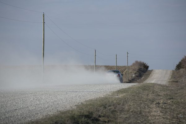 Dust is seen being kicked up from from a car driving down a gravel road outside os Solon, Iowa on Thursday, March 21, 2024.