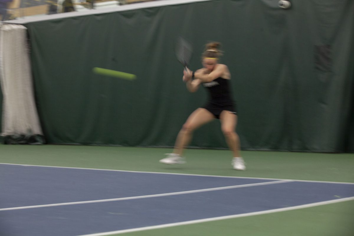 Northwestern’s Kiley Rabjohns hits the ball during a tennis match between No. 75 Iowa and No. 35 Northwestern at the Hawkeye Tennis and Recreation Center on Sunday, March 24, 2024. The Wildcats defeated the Hawkeyes, 1-4.