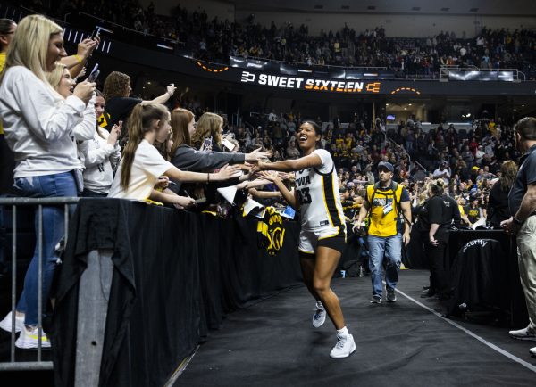 Iowa forward Jada Gyamfi high-fives fans during an NCAA Tournament Sweet Sixteen game between No. 1 Iowa and No. 5 Colorado at MVP Arena in Albany, N.Y., on Saturday, March 30, 2024.