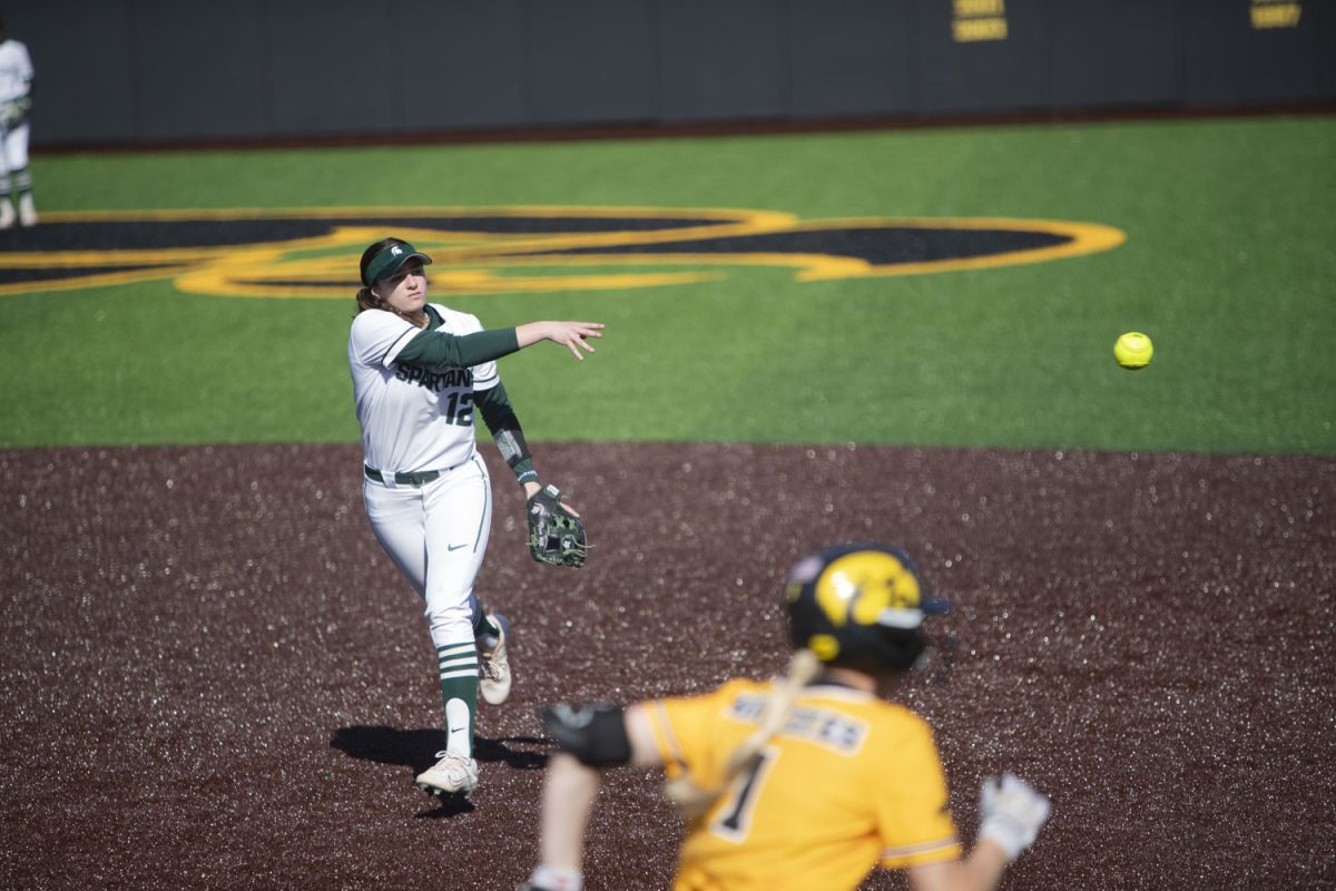 Michigan State infielder Anna Fox throws the ball to first base to get a force-out on Iowa infielder Tory Bennett during the second of two softball games between Iowa and Michigan State at Bob Pearl Field on Saturday, March 30, 2024. The Hawkeyes defeated the Spartans 1-0.