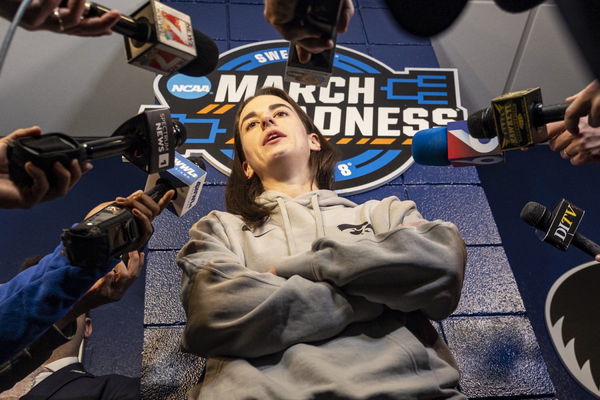 Iowa guard Caitlin Clark answers questions from reporters during a day of press conferences and open locker rooms ahead of a NCAA Tournament Elite Eight game between No. 1 Iowa and No. 3 LSU at MVP Arena in Albany, N.Y., on Sunday, March 31, 2024.