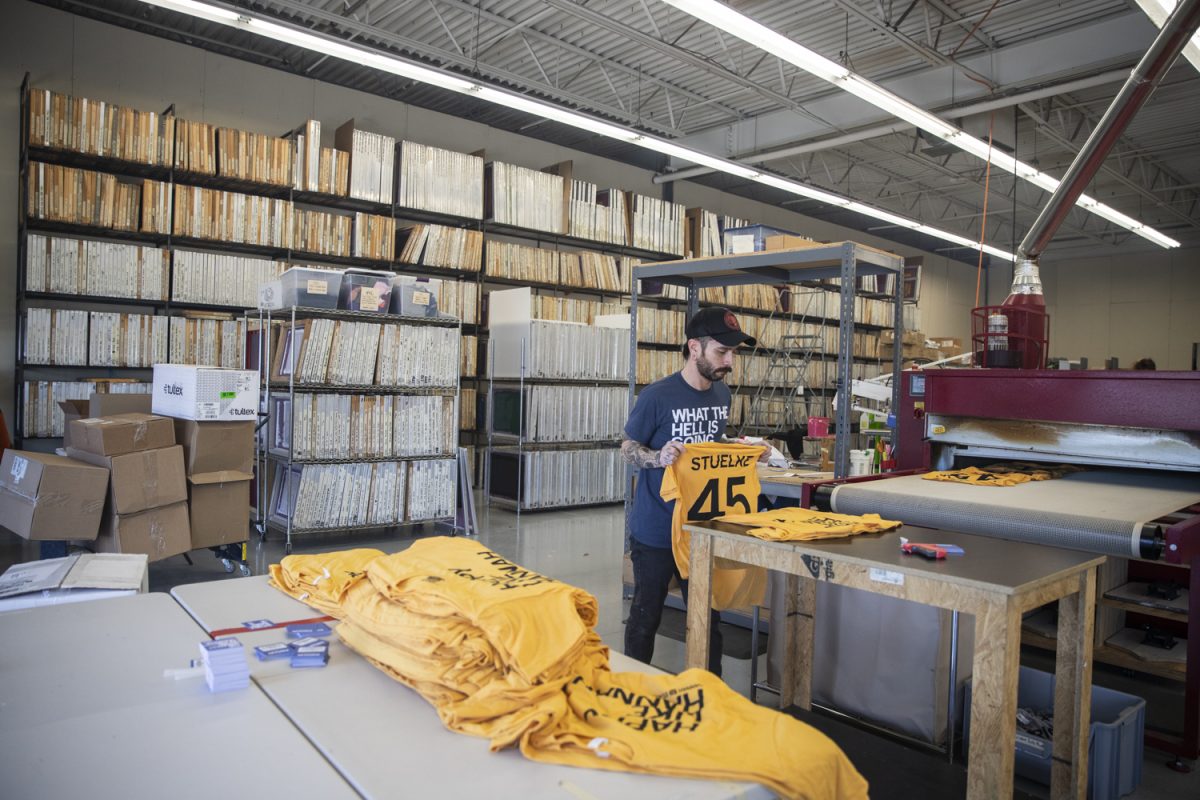 A member of Raygun staff works on Hannah Stuelke shirts at the Raygun Printing Facility in Des Moines on Feb. 9, 2024. Raygun increased their supply of Stuelke shirts following her record-breaking 47 point game at Carver-Hawkeye Arena the previous night.