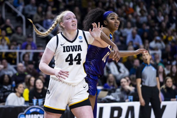 Iowa center Addison OGrady and LSU forward Angel Reese fight for a spot in the lane during an NCAA Tournament Elite Eight game between No. 1 Iowa and No. 3 LSU at the Hilton Hotel in Albany, N.Y., on Monday, April 1, 2024. The Hawkeyes defeated the Tigers, 94-87.