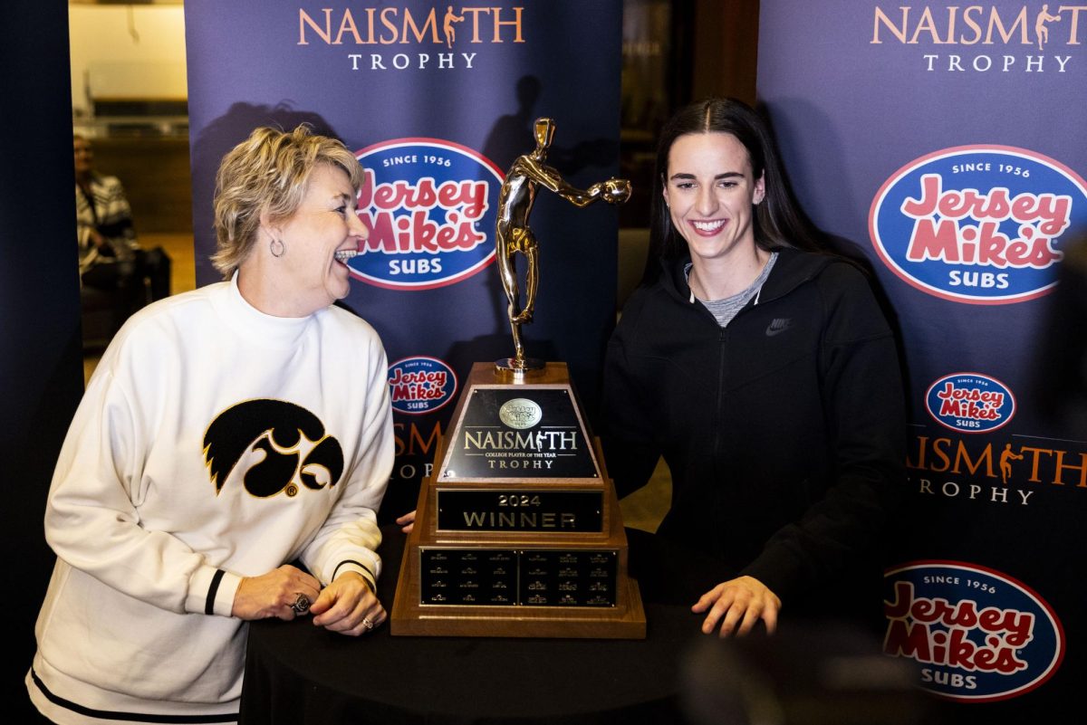 Iowa guard Caitlin Clark and Iowa head coach Lisa Bluder pose for a photo after Clark won the Naismith Player of the Year Award at Cleveland Browns Stadium in Cleveland, Ohio, on Wednesday, April 3, 2024.