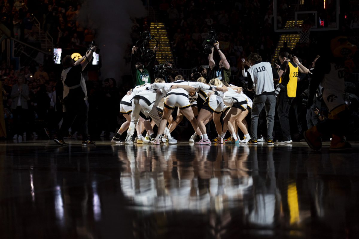 The Iowa women’s basketball team huddles up during a NCAA Tournament Final Four game between No. 1 Iowa and No. 3 UConn at Rocket Mortgage FieldHouse in Cleveland, Ohio, on Friday, April 5, 2024. (Ayrton Breckenridge/The Daily Iowan)