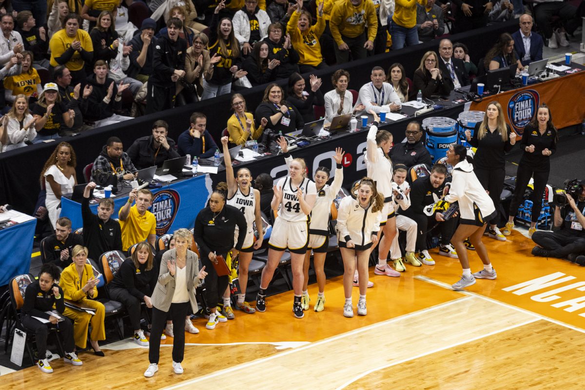 Members of the Iowa women’s basketball team cheer during a NCAA Tournament Final Four game between No. 1 Iowa and No. 3 UConn at Rocket Mortgage FieldHouse in Cleveland, Ohio, on Friday, April 5, 2024. (Ayrton Breckenridge/The Daily Iowan)