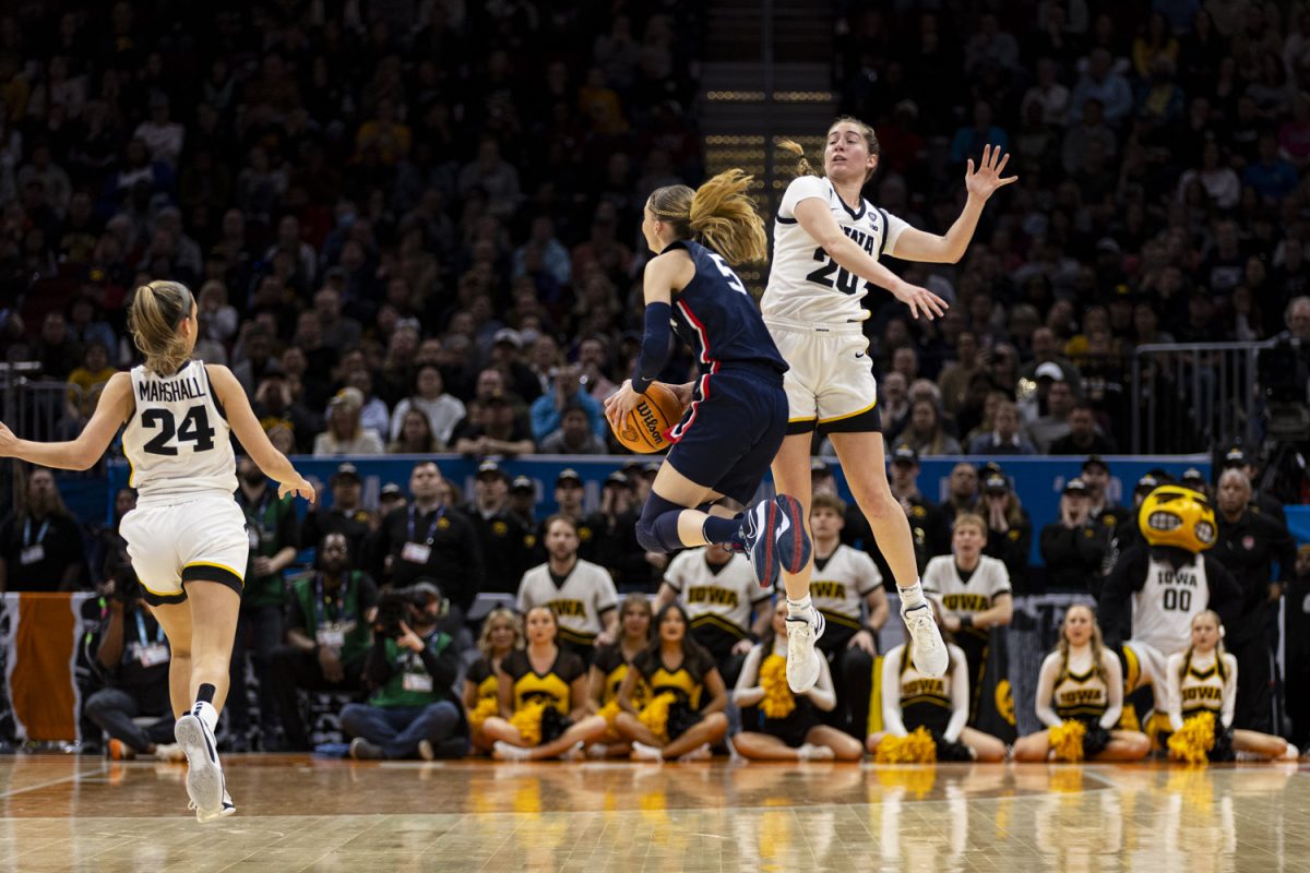 Iowa guard Kate Martin attempts to block UConn guard Paige Bueckers’ shot during a NCAA Tournament Final Four game between No. 1 Iowa and No. 3 UConn at Rocket Mortgage FieldHouse in Cleveland, Ohio, on Friday, April 5, 2024. (Ayrton Breckenridge/The Daily Iowan)
