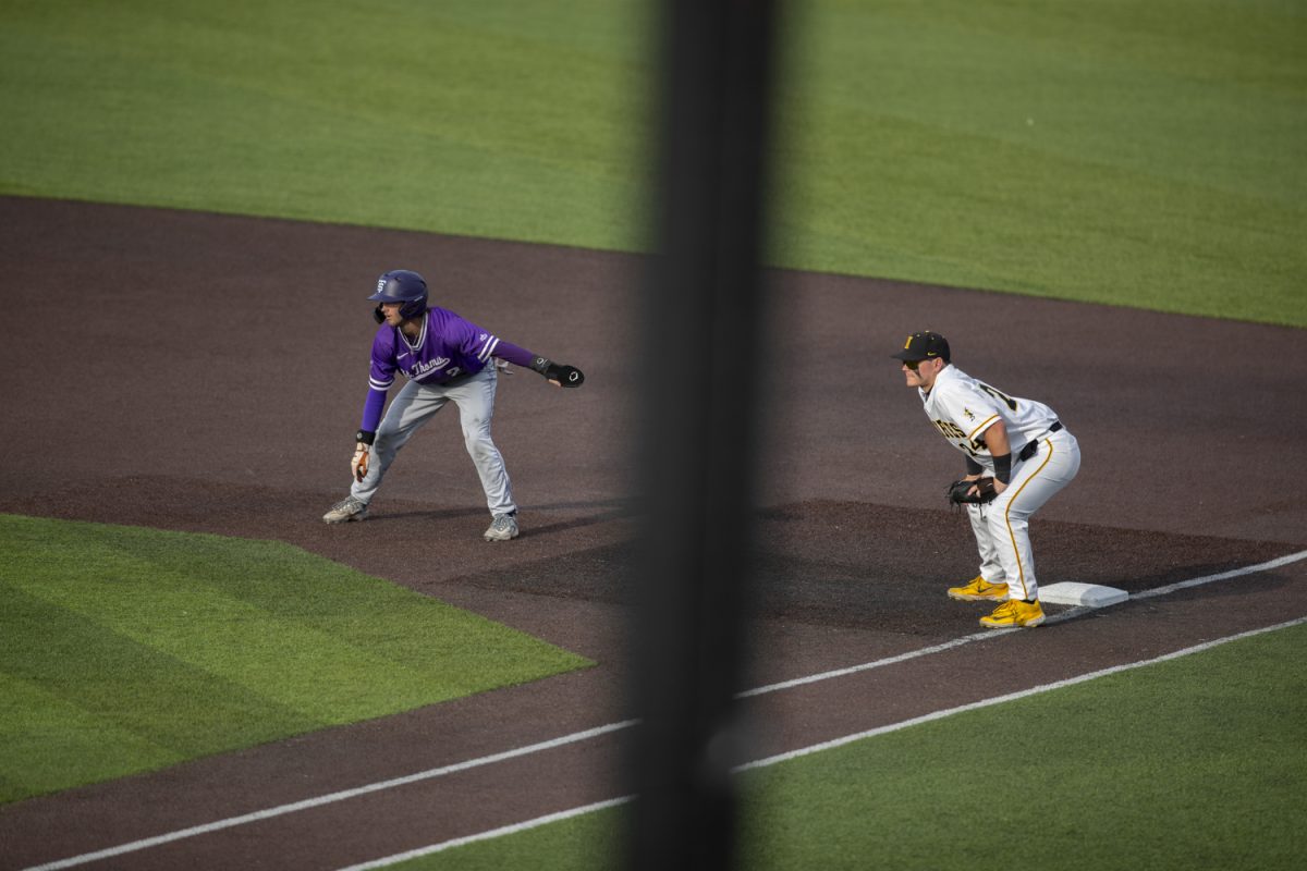 St. Thomas infielder Tanner Recchio and Iowa infielder Davis Cop watch a pitch during a baseball game between St. Thomas and Iowa at Duane Banks Field in Iowa City, Iowa. The Hawkeyes defeated the Tommies 17-11.