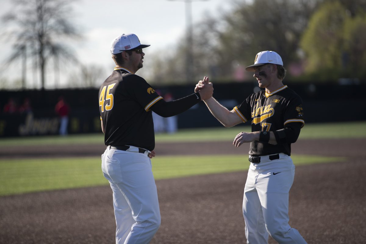 Iowa infielder Blake Guerin and utility player Andy Nelson embrace before a baseball game between Bradley and Iowa at Duane Banks Field in Iowa City, Iowa. The Hawkeyes defeated the Braves 11-6.