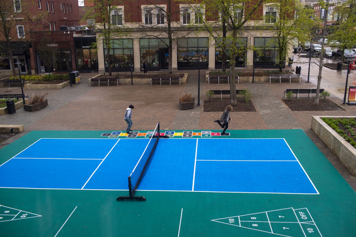 People play hopscotch on a pickleball court in downtown Iowa City on Thursday, April 18, 2024.