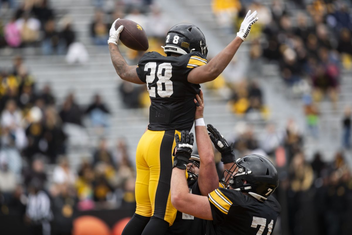 Iowa running back Kamaro Moulton celebrates with teammates after a touchdown during an Iowa football spring practice at Kinnick Stadium in Iowa City on Saturday, April 20, 2024.